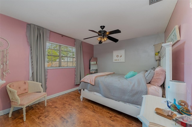 bedroom with ceiling fan and hardwood / wood-style floors