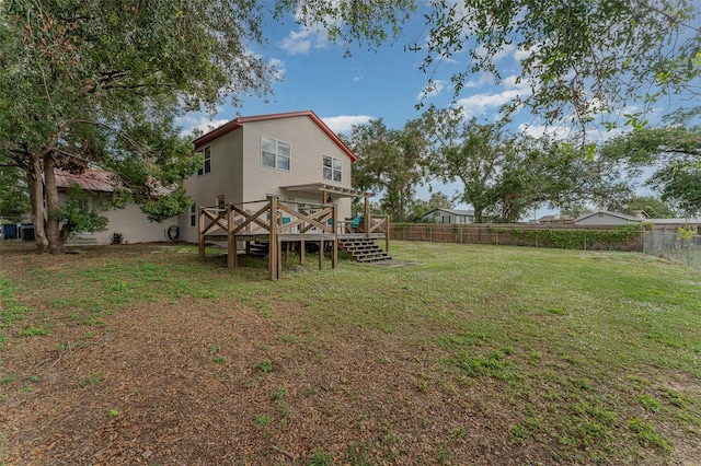 view of yard featuring a wooden deck and central AC