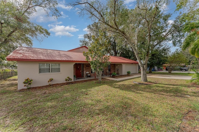 ranch-style house featuring a garage and a front yard