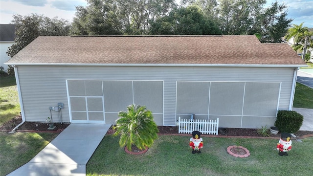 view of front facade with a sunroom and a front yard