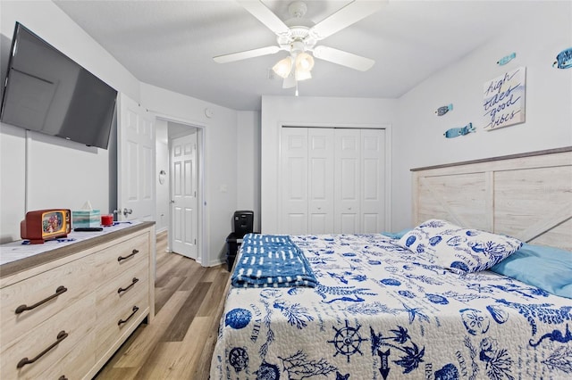 bedroom featuring a closet, light hardwood / wood-style floors, and ceiling fan