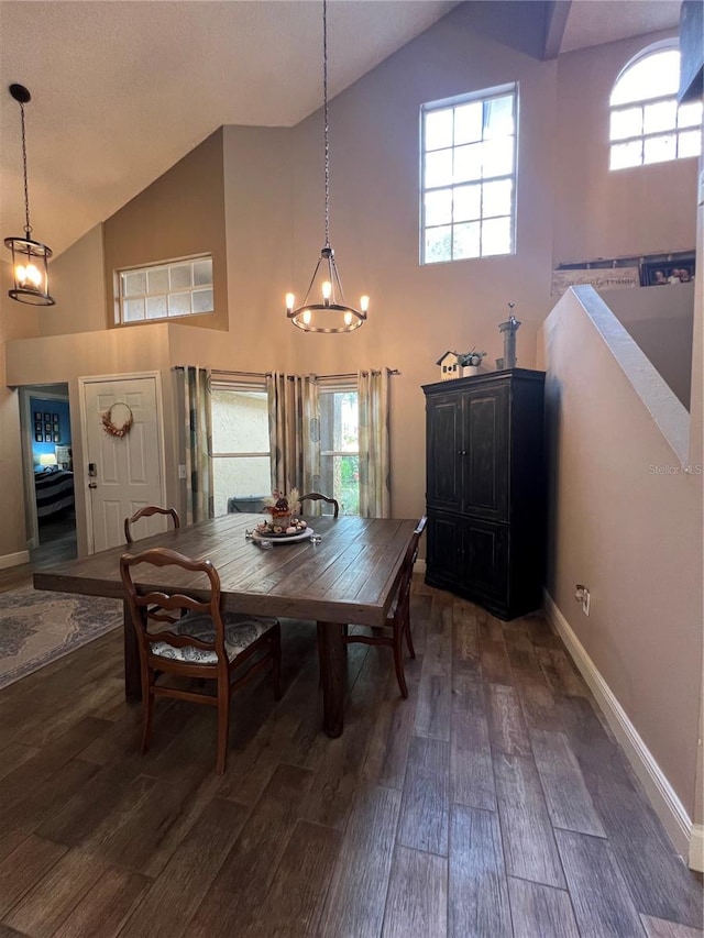 dining room featuring a notable chandelier, dark hardwood / wood-style flooring, and high vaulted ceiling