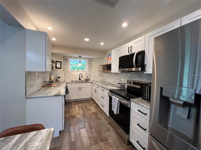 737 Butternut Pl, Lakeland, FL 33813 - kitchen featuring stainless steel appliances, dark wood-style flooring, decorative backsplash, open shelves, and recessed lighting