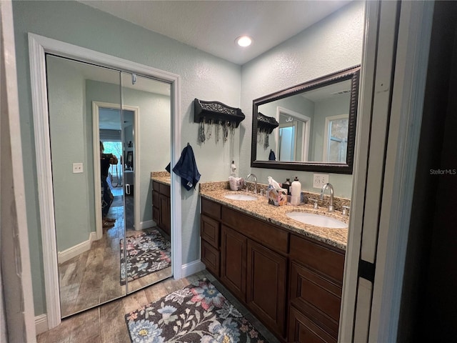 bathroom with vanity and hardwood / wood-style flooring