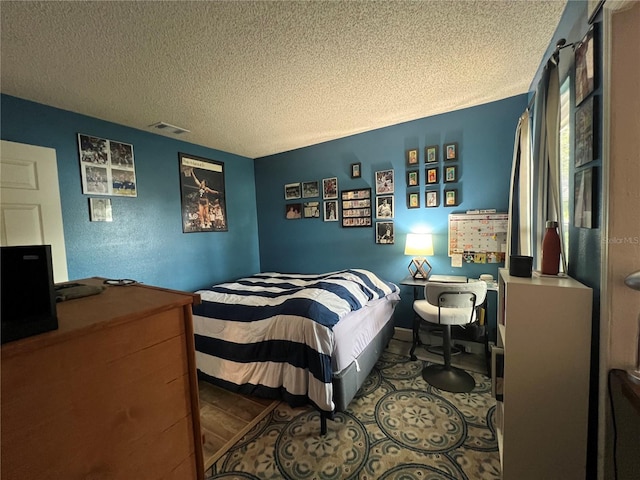 bedroom featuring a textured ceiling