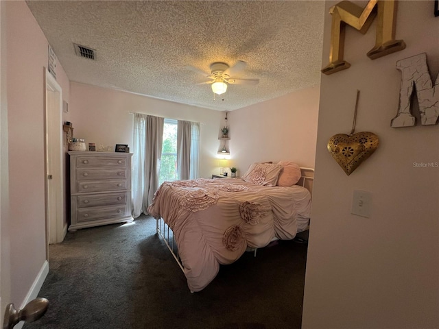 bedroom with dark colored carpet, a textured ceiling, and ceiling fan