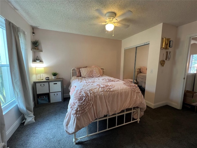 737 Butternut Pl, Lakeland, FL 33813 - carpeted bedroom with a closet, a textured ceiling, ceiling fan, and baseboards