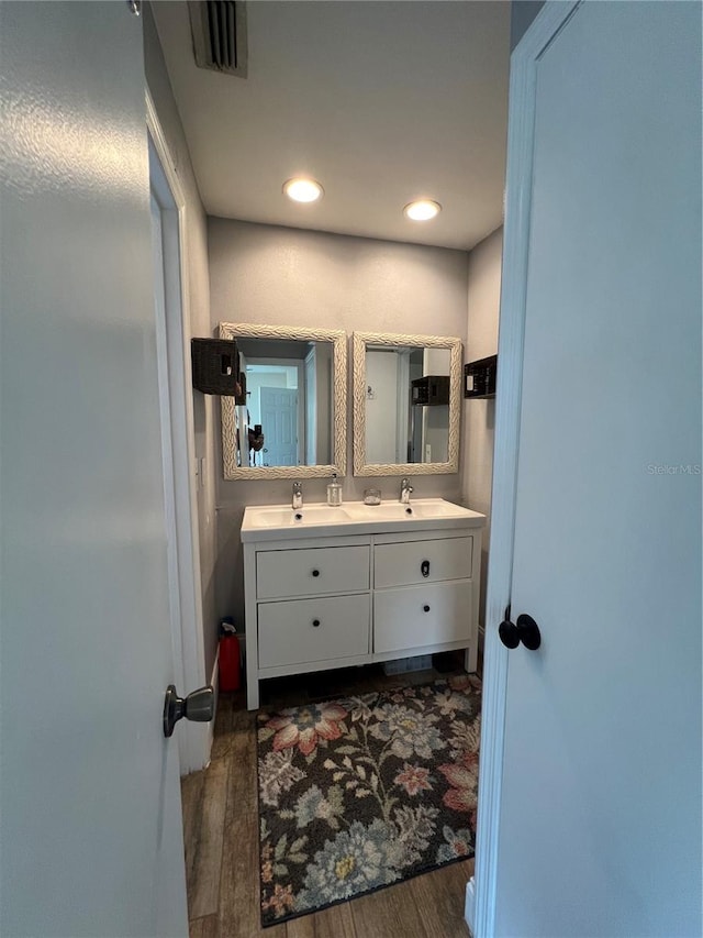 bathroom with hardwood / wood-style flooring and vanity