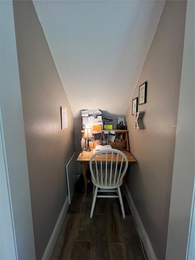 hallway featuring wood-type flooring and vaulted ceiling