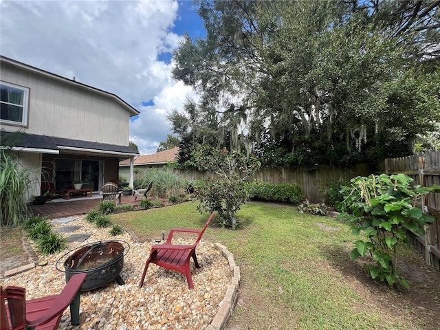 view of yard featuring a patio and an outdoor fire pit