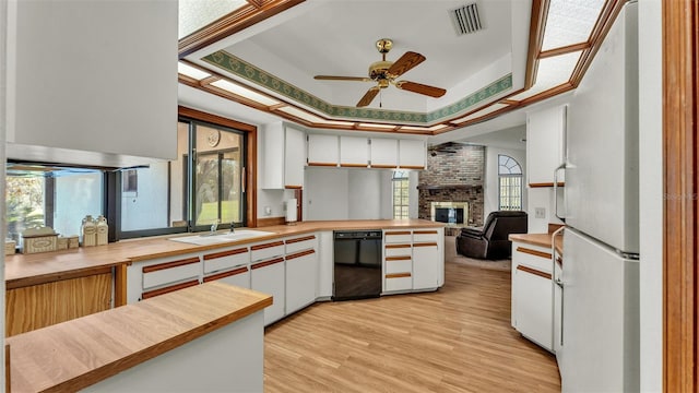 kitchen with white cabinets, white fridge, and a tray ceiling