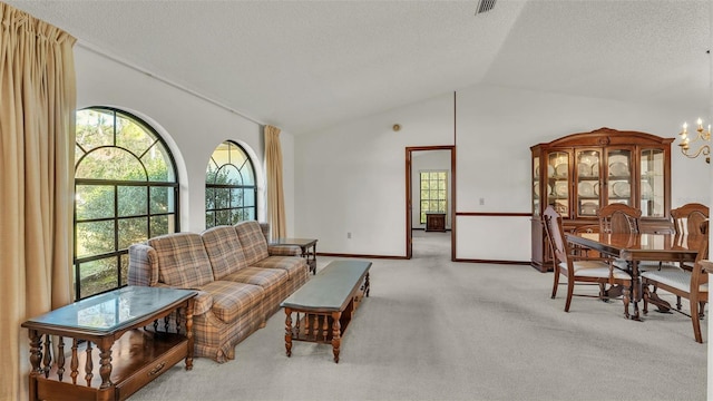 living room featuring a textured ceiling, a chandelier, light colored carpet, and lofted ceiling