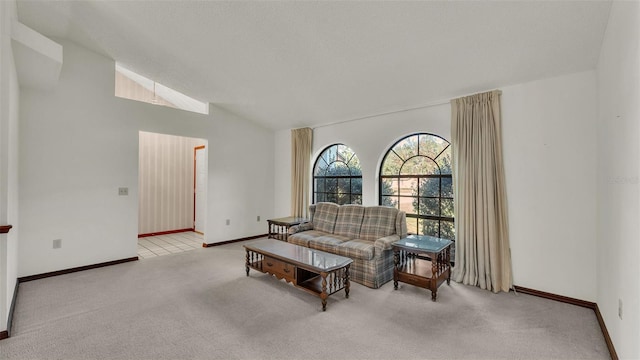 living area featuring a textured ceiling, light colored carpet, and lofted ceiling