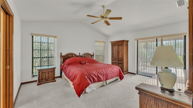 bedroom featuring ceiling fan, light colored carpet, lofted ceiling, and a textured ceiling