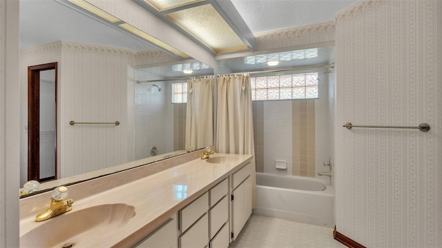 bathroom featuring shower / bath combination with curtain, a textured ceiling, and vanity