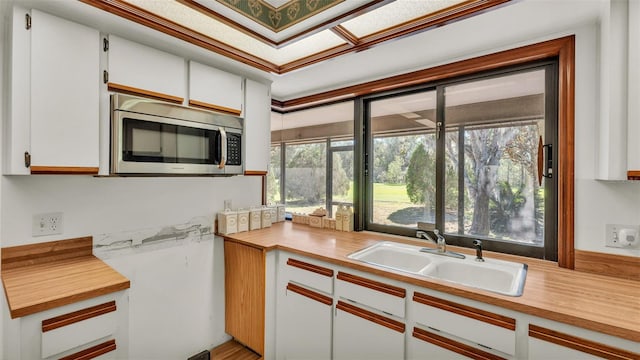 kitchen featuring white cabinetry and sink