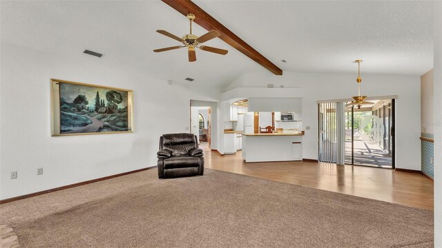 living area with a textured ceiling, vaulted ceiling with beams, light hardwood / wood-style flooring, and ceiling fan