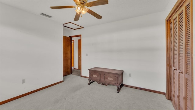 bedroom featuring ceiling fan, light colored carpet, and a closet