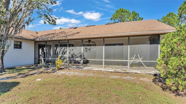 back of property featuring a sunroom and a yard