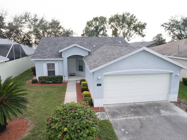 view of front of house with a front yard and a garage