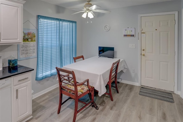 dining space with ceiling fan and light hardwood / wood-style flooring