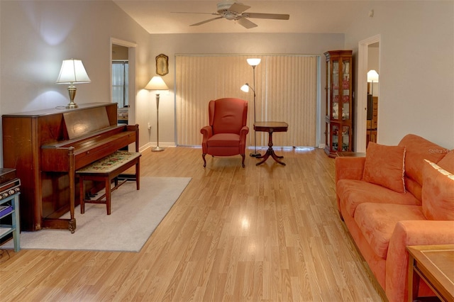 sitting room featuring light wood-type flooring, ceiling fan, and lofted ceiling