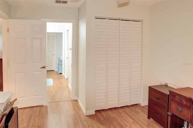 bedroom with a closet and light hardwood / wood-style flooring