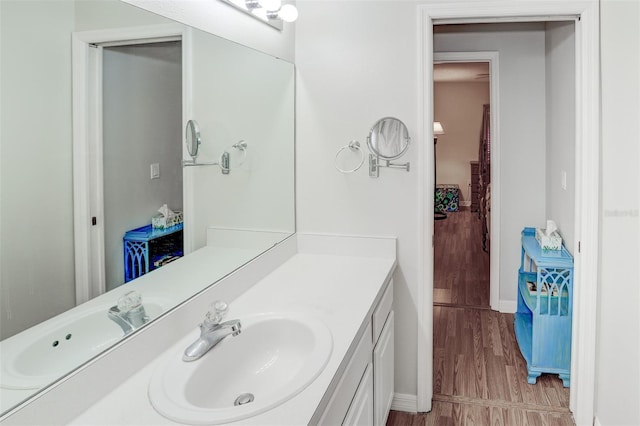 bathroom with hardwood / wood-style floors and vanity