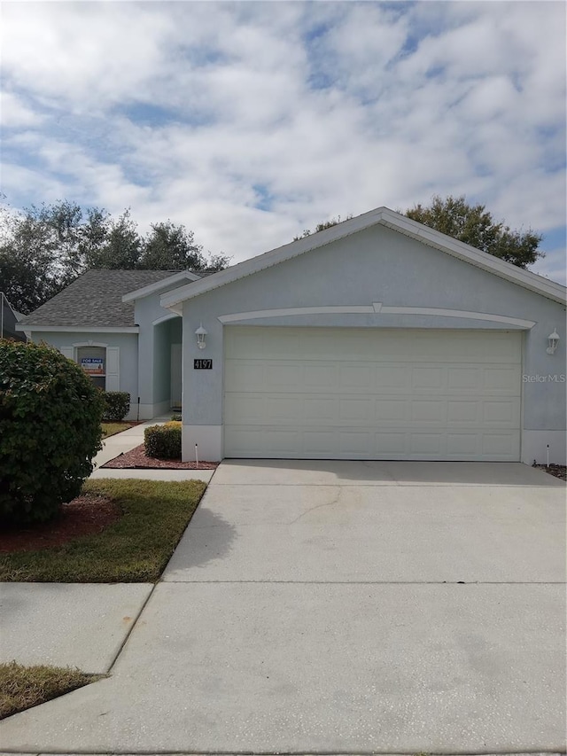 single story home featuring a garage