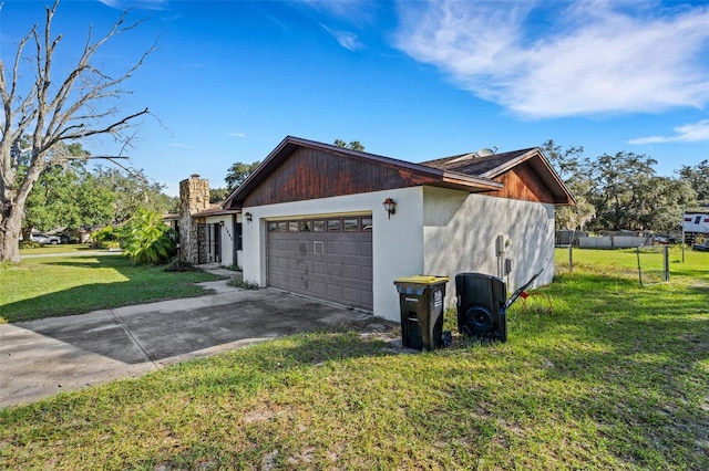 view of home's exterior featuring a yard and a garage