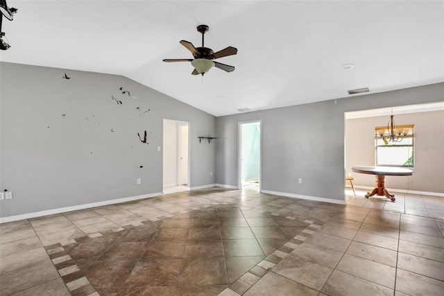 tiled spare room featuring ceiling fan with notable chandelier and vaulted ceiling