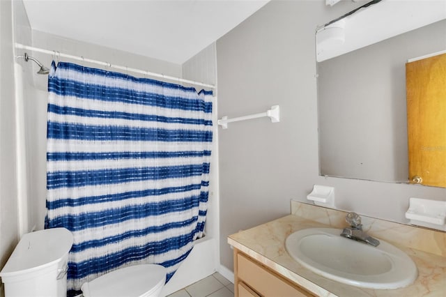 bathroom featuring tile patterned flooring, vanity, and toilet