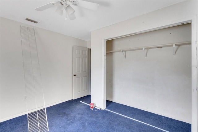 unfurnished bedroom with a closet, dark carpet, and ceiling fan