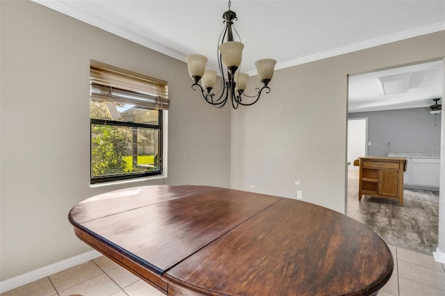 tiled dining area with ceiling fan with notable chandelier and ornamental molding