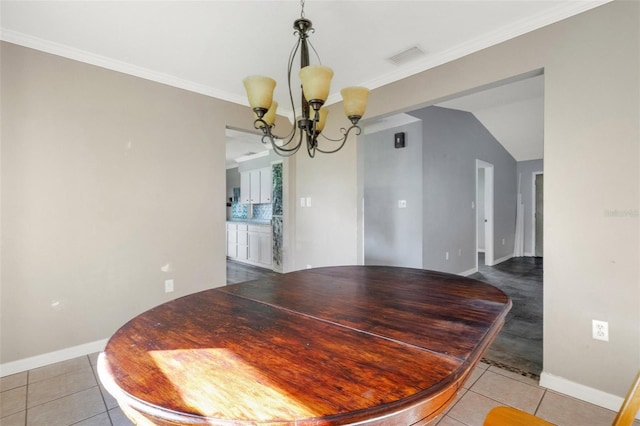 tiled dining room with crown molding, vaulted ceiling, and an inviting chandelier