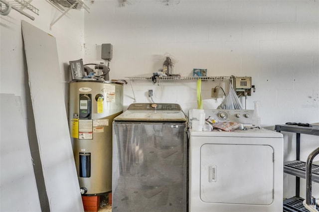 washroom with electric water heater and washer and dryer