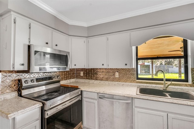 kitchen with white cabinets, decorative backsplash, sink, and stainless steel appliances