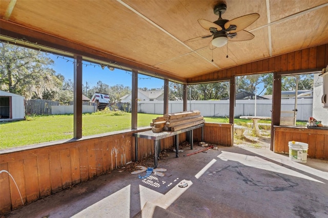 sunroom featuring a wealth of natural light, lofted ceiling, and ceiling fan