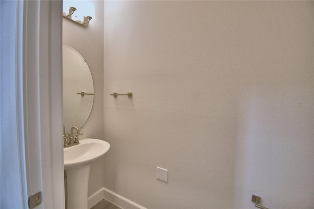 half bathroom with baseboards