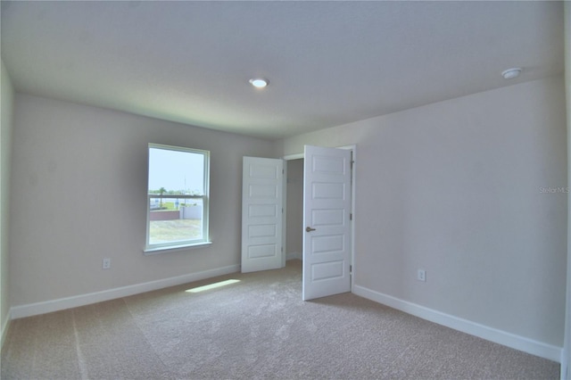 unfurnished bedroom with baseboards and carpet flooring