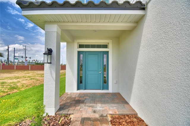 property entrance featuring stucco siding