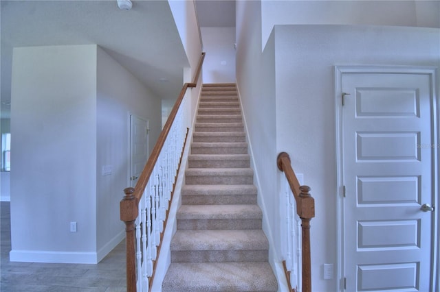 stairs featuring baseboards and wood finished floors