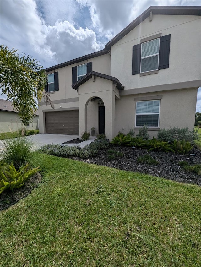 view of front of house with a garage and a front lawn