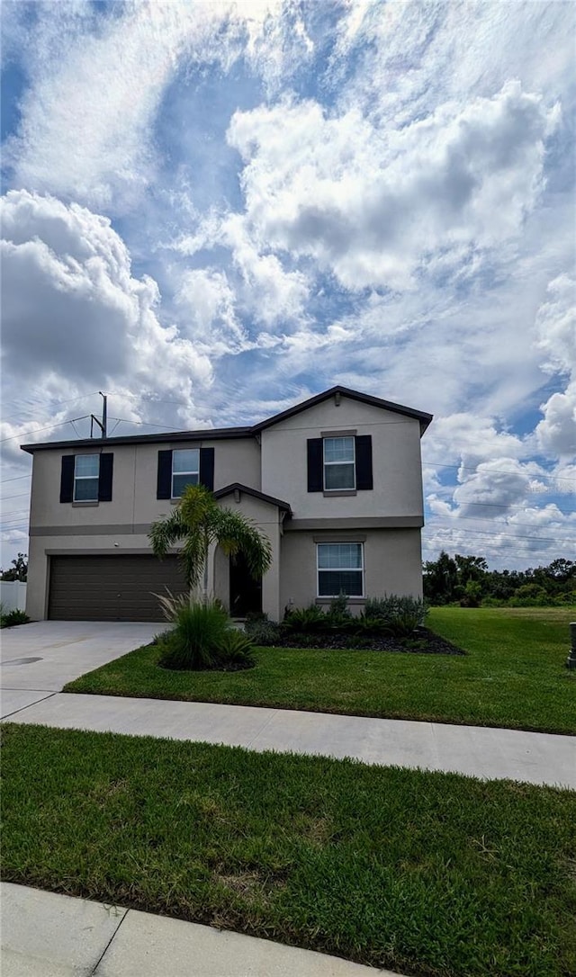 view of front of property with a front yard and a garage