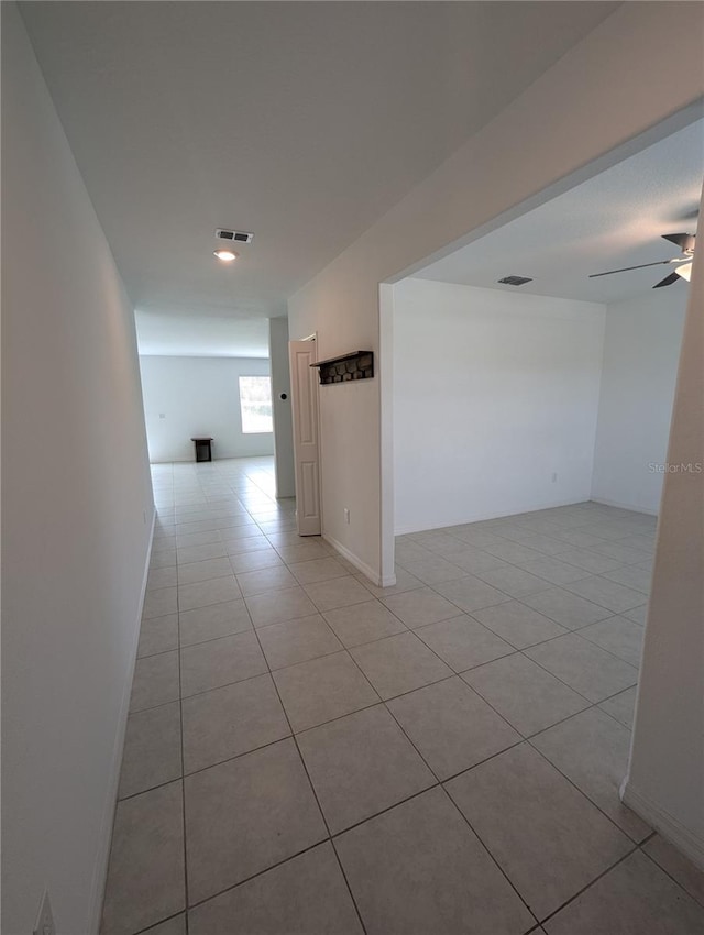 hall featuring light tile patterned floors