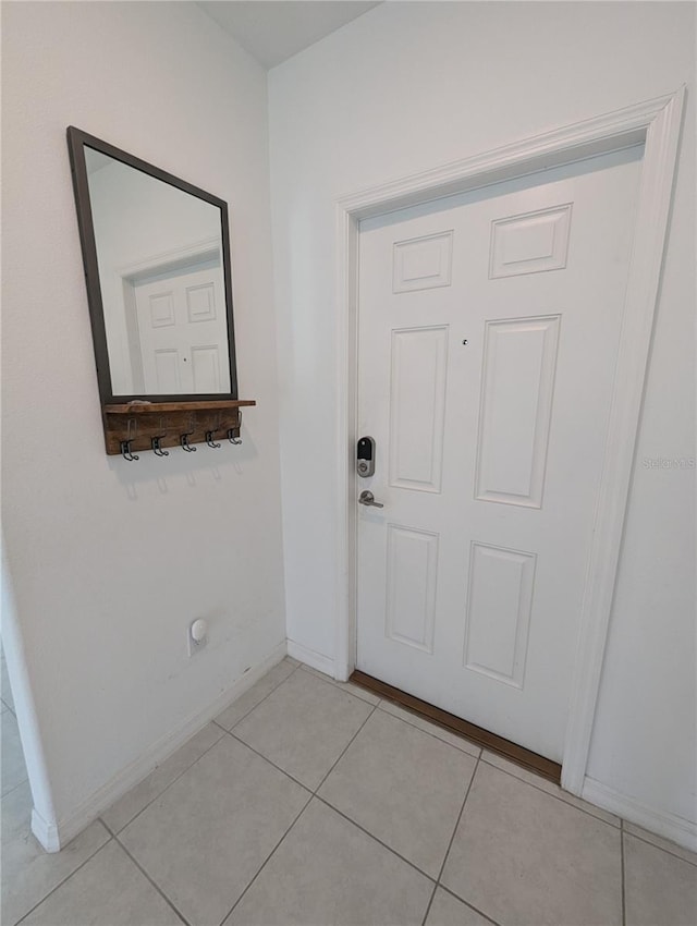 entryway with light tile patterned floors