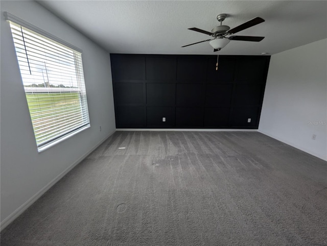 unfurnished room with ceiling fan and carpet floors