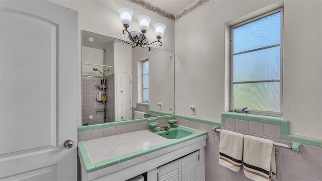 bathroom with vanity, a tile shower, and tile walls