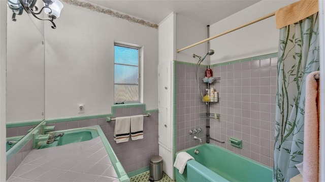 bathroom with vanity, tile walls, and shower / tub combo