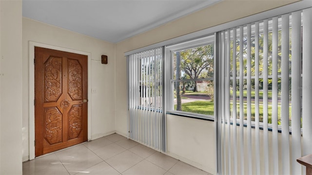 doorway with plenty of natural light and light tile patterned flooring